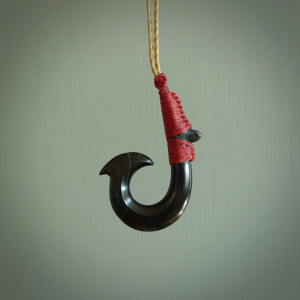 These pendants are hand carved, black jade Hawaiian hooks or Makau pendants. They are beautifully finished in a high polish and bound with a deep Pohutukawa red cord and a Kalahari tan necklace. Hand made jewellery that make the most wonderful gifts. Free shipping worldwide.
