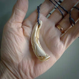 Hand carved incredible Boars Tusk Japanese catfish carving. A stunning work of art. This pendant was hand carved in boars tusk with Goat Horn inlay for the eyes by Fumio Noguchi. A one off collectors item that has been hand crafted to be worn or displayed. Hand made boars tusk Namazu earthquake fish necklace.