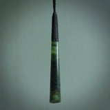This photo shows a large jade drop shaped pendant. It a a lovely two-one green jade. Majority of this piece is a dark green colour with a semi-translucent top of the drop. The cord is black and is adjustable in length. Hand carved by Darren Hill.