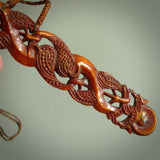 This necklace is carved from cow bone and stained with a homemade tea dye. It is a unique piece of wearable art that is sure to catch the eye. The shape is a complex twist form and has been beautifully hand carved by bone carver Yuri Terenyi.