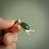 New Zealand Jade stone turtle in Sterling silver engraved casing. Hand carved jewellery made by NZ Pacific and for sale online. Moana, Ocean, jewellery hand carved in fire agate and Sterling Silver turtle necklace.