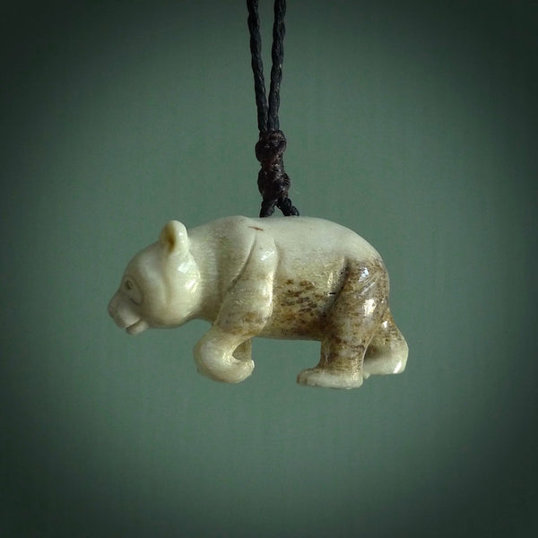 This picture shows a pendant that we designed in Woolly Mammoth Tusk. It is a little Panda bear that has a walking stance and is carved in detail. A really attractive and eye-catching piece of handmade jewellery. The cord is hand plaited braid in black and the length can be adjusted.
