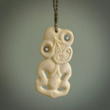 Hand carved bone Tiki pendant. Traditional art hand carved for NZ Pacific by Yuri Terenyi. Bone Tiki necklace with Paua Shell eyes.
