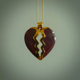 This is a handcarved love heart pendant made from a gorgeous and striking piece of red jasper stone with gold plated silver. This is a superbly carved and very unique piece if custom jewellery. For sale online from NZ Pacific.