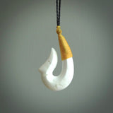 Hand carved white onyx pendant. Hook, matau pendant hand made in New Zealand. NZ Pacific jewellery for sale online.
