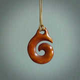 Stained natural cow bone hook with koru pendant. Hand carved by Yuri Terenyi in New Zealand. Maori design pendant for sale online. One only natural bone hook with koru necklace. Free delivery worldwide.
