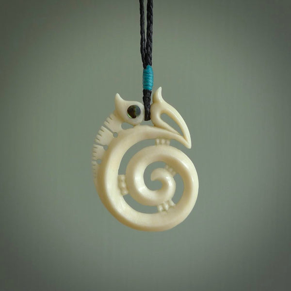 This is a unique manaia with koru, hand carved natural bone pendant with Paua Shell eyes. The cord is Black and is length adjustable. This is delivered to you with Express Courier. The eyes are made from Paua shell.