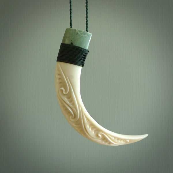 Boars Tusk Pendant with a jade cap. Hand made pendant carved from a boars tusk. Hand made ethnic or maori jewellery for sale by NZ Pacific online.