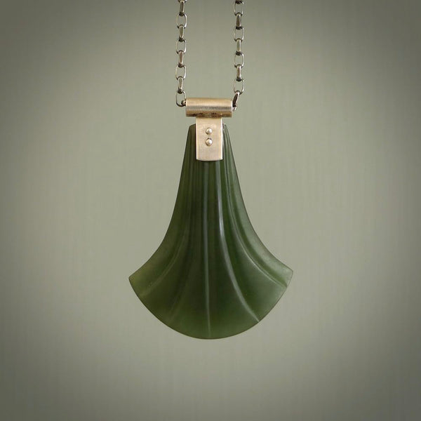 This is a very dark green shield style design pendant that has been carved here in New Zealand by Josey Coyle. It is carved from a piece of New Zealand Marsden Jade pounamu with Sterling Silver fittings and a sterling silver chain. A stunning contemporary necklace made to wear.