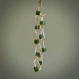 This bracelet is handmade from New Zealand Jade and sterling silver. It has a delicate cube of pounamu within each link of Sterling Silver chain and the Jade moves within each chain link.