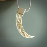 Hand carved, engraved Boars Tusk Pendant with a sterling silver cap. Hand made pendant carved from a boars tusk. Hand made unique jewellery for sale by NZ Pacific online.