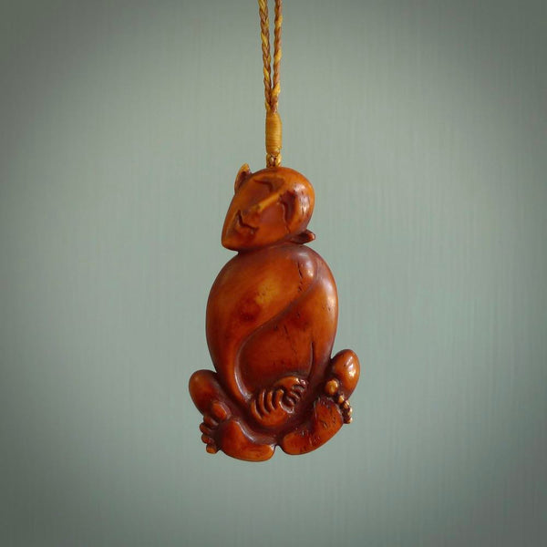 Hand carved stained bone meditating male figure pendant. Made from natural bone. Bone jewellery from the Pacific for sale online. Male pendant for men and women.