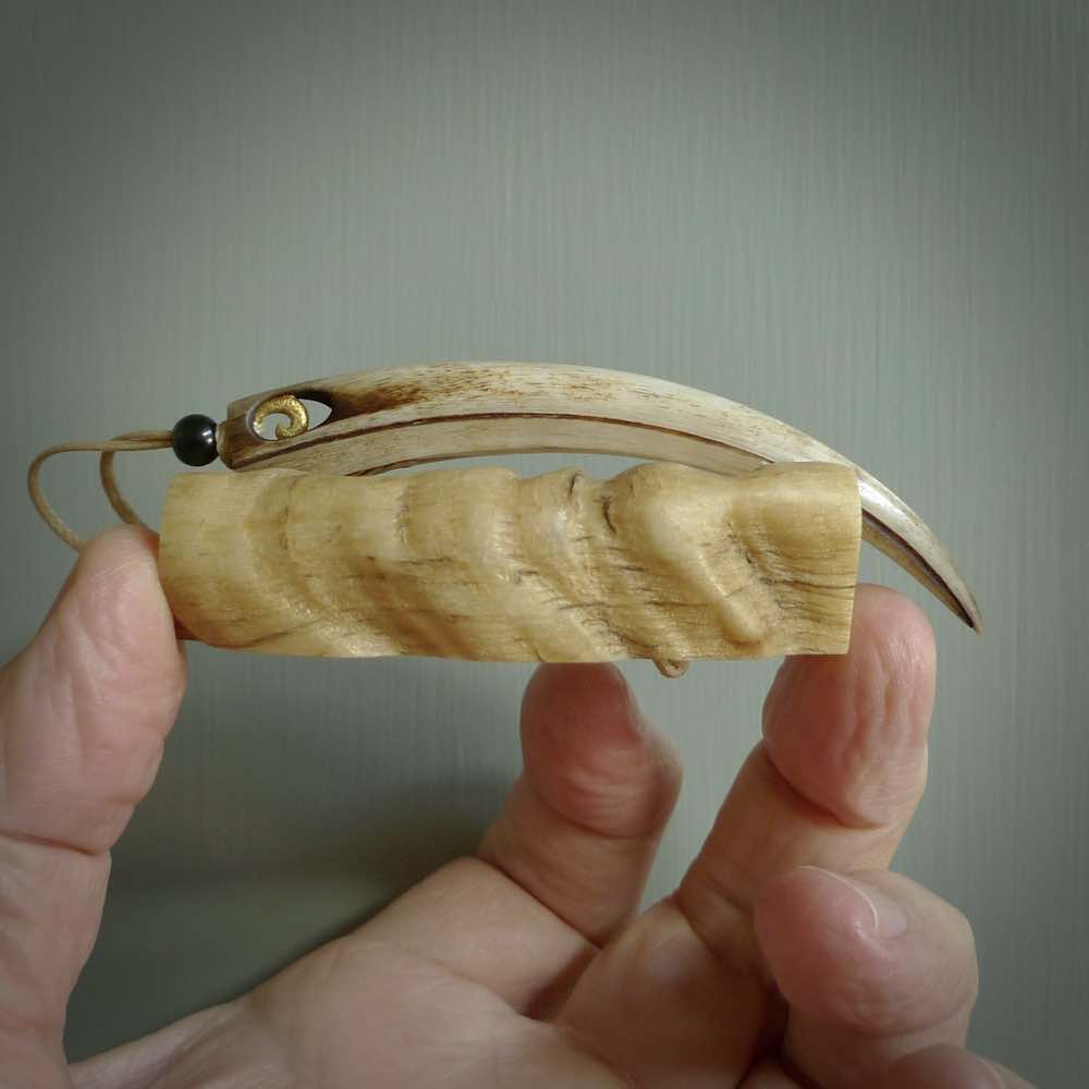 This is a hand carved rams horn huia bird beak pendant. It is made from rams horn with 24 carat gold leaf and jade toggle. This is a large sized necklace and is a very unique, one only, pendant that is a collectors piece. Hand carved by New Zealand artist, Sami.