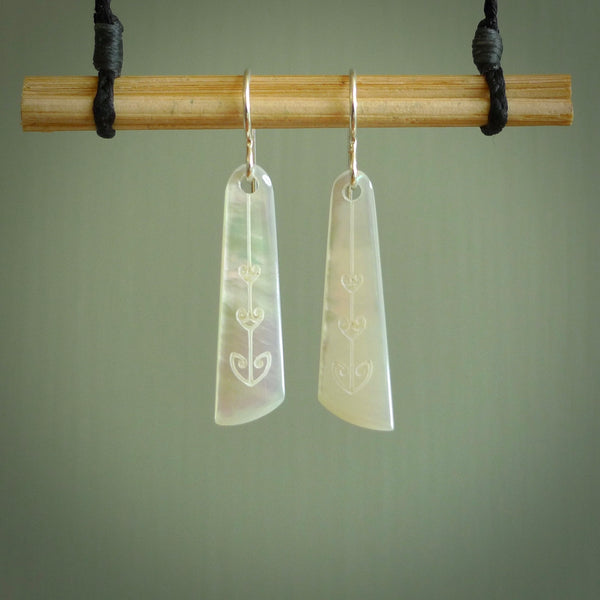 Hand carved New Zealand mother of pearl drop with koru design earrings hand made by Kerry and Amanda Thompson. One only large drop earrings. Real New Zealand Mother of Pearl art to wear. Free Shipping worldwide.