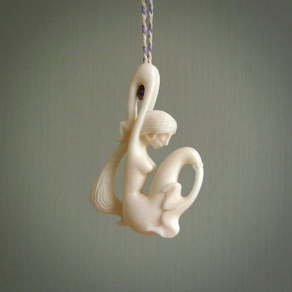 This pendant is a gorgeous and intricately carved mermaid pendant. Carved by renowned bone carver Yuri Terenyi for us. This is a little masterpiece. It is a mermaid with her arms clasped around her tail. The craftsmanship displayed in this piece is extraordinary - a collectors item, or a piece to wear and love.