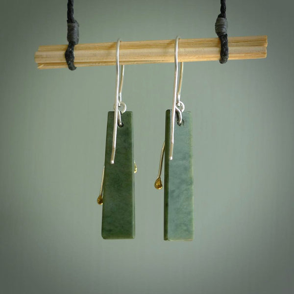 These kowhai flower drop earrings are beautifully hand made with gorgeous flair. They are fashionable and perfect for a women with style. Hand carved from a gorgeous piece of New Zealand Marsden jade with Gold leaf coating and sterling silver hooks - they are elegant and beautiful.