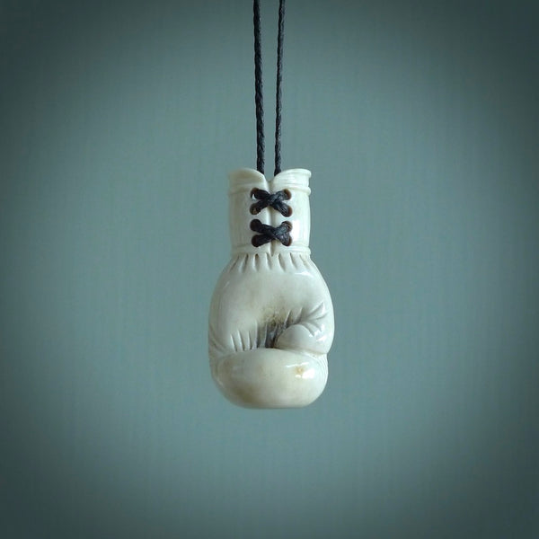 Hand carved boxing glove made from deer antler. The cord is adjustable so that you can wear this where it suits you best.
