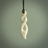 A hand carved twist design pendant from Whale Bone. The cord is black and adjustable in length. Large hand made twist necklace by New Zealand artist Kerry Thompson.