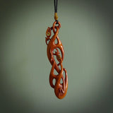 A one off beautiful piece of carved art. Hand carved for us by Yuri Terenyi and is a double manaia pendant. This is a wonderful ethnic bone pendant designed to be worn. It has been stained by a homemade tea dye in a bright gingery brown colour and we have hand plaited an adjustable cord in black with a burnt gold floret popper.