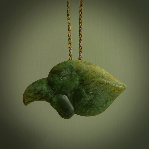 This picture shows a flower jade birds head. The bird is an extinct kokako - a saddleback that used to line in New Zealand's South Island. The cord is plaited and length adjustable. It is in two colours - khaki and burnt gold. We ship this worldwide.