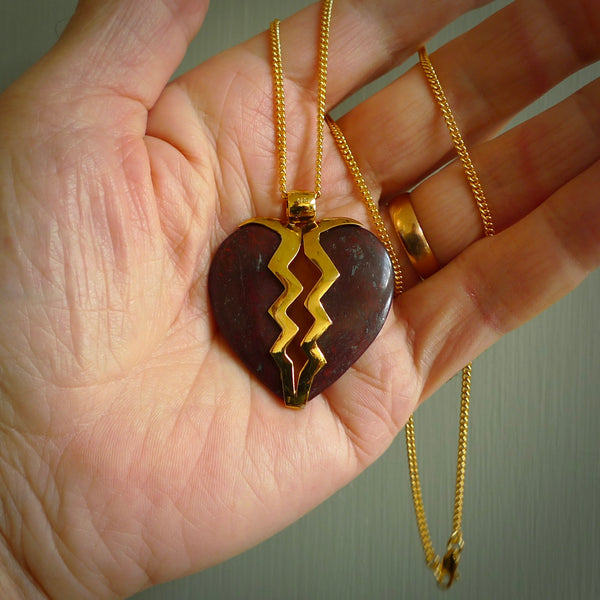 This is a handcarved love heart pendant made from a gorgeous and striking piece of red jasper stone with gold plated silver. This is a superbly carved and very unique piece if custom jewellery. For sale online from NZ Pacific.