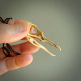 This is a hand carved deer antler huia bird skull pendant. It is made from deer antler, bone. This is a large sized necklace and is a very unique, one only, pendant that is a collectors piece. Hand carved deer antler huia skull necklace for men and women.