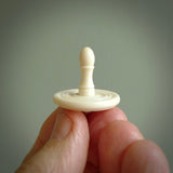 A traditional hand carved bone spinning top toy. This piece is made from bone and is a fully functioning toy that can be played with. Beautiful, contemporary art hand made by NZ Pacific.