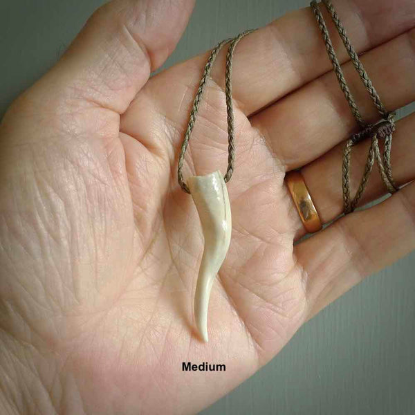 Deer Antler Bone Italian Horn pendant. Handmade bone jewellery made by NZ Pacific and for sale online. Deer Antler  Goat Horn pendant worn for protection over evil eye, bad luck and promotes fertility. Ancient symbolic necklace hand made in Deer Antler, Bone.