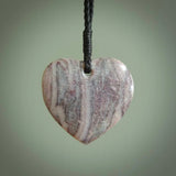 A hand carved heart pendant made from New Zealand Rhodonite Stone. This is a medium sized and visually striking piece, beautifully curved and sensuous. The perfect piece of jewellery for someone you love.