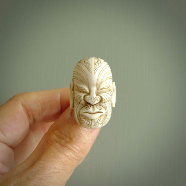 Hand carved Moko man face ring. Made from Red Deer antler in New Zealand. Unique Moko Man ring hand made from deer antler by master bone carver Fumio Noguchi. Spectacular collectable work of art, made to wear. One only ring, delivered to you at no extra cost with express courier.