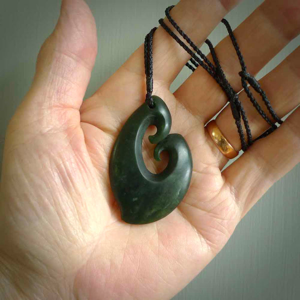 A hand carved large sized contemporary kour pendant. This is a piece of genuine jade jewellery, hand carved by Ric Moor. He has used New Zealand jade and has utilised his experience and carving skill to highlight the natural beauty of the stone. Delivered worldwide, postage is included in the price.
