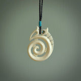 This is a unique manaia with koru, hand carved natural bone pendant with Paua Shell eyes. The cord is Black and is length adjustable. This is delivered to you with Express Courier. The eyes are made from Paua shell.