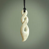 A hand carved twist design pendant from Whale Bone. The cord is black and adjustable in length. Large hand made twist necklace by New Zealand artist Kerry Thompson.