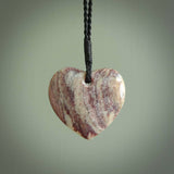 A hand carved heart pendant made from New Zealand Rhodonite Stone. This is a medium sized and visually striking piece, beautifully curved and sensuous. The perfect piece of jewellery for someone you love.
