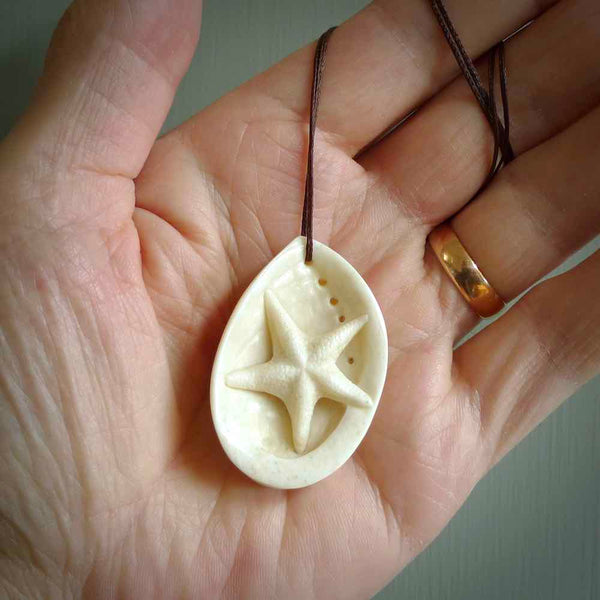 Hand carved bone paua shell with starfish inside pendant. Made from Bone in New Zealand. Unique Pāua Shell necklace hand made from bonoe with starfish carving inside the shell. Made by master bone carver Fumio Noguchi. Spectacular collectable work of art, made to wear. One only pendant, delivered to you at no extra cost with express courier.