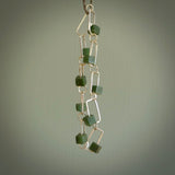 This bracelet is handmade from New Zealand Jade and sterling silver. It has a delicate cube of pounamu within each link of Sterling Silver chain and the Jade moves within each chain link.