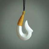 Hand carved white onyx pendant. Hook, matau pendant hand made in New Zealand. NZ Pacific jewellery for sale online.