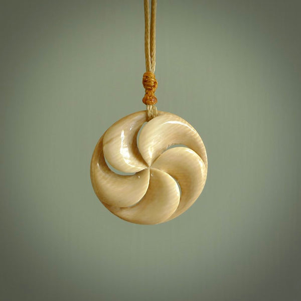 Hand carved koru style pendant. Made from Woolly Mammoth Tusk.