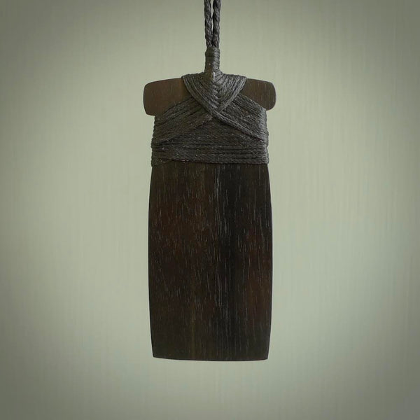 This photo shows wooden toki pendants. The cord is length adjustable which allows the pendant to be positioned where it suits you best. The toki was carved for us in hard wood. Unique art to wear.