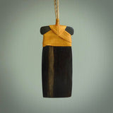 This photo shows wooden toki pendants. The cord is length adjustable which allows the pendant to be positioned where it suits you best. The toki was carved for us in hard wood. Unique art to wear.