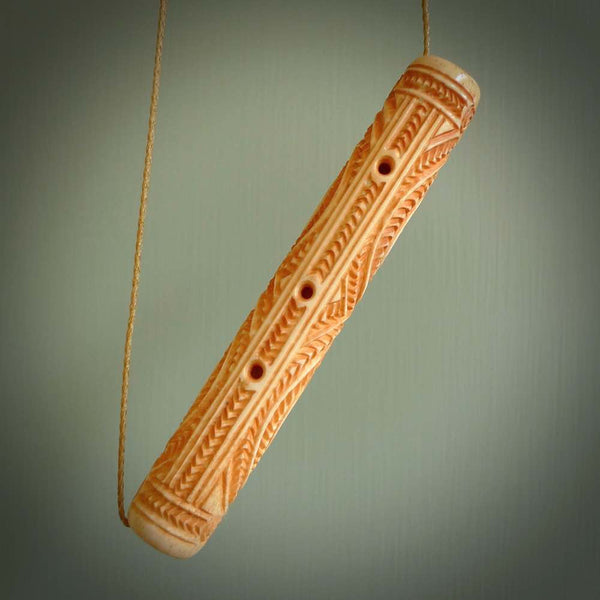 A traditional hand carved Māori flute. This piece is made from bone and is a fully functioning musical instrument and can be played. Beautiful ethnic art hand made by NZ Pacific.