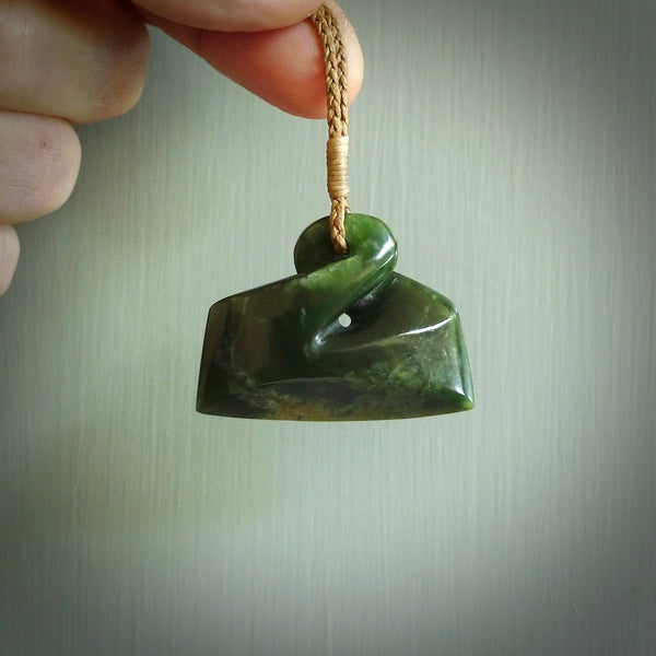Hand carved large flower jade pikorua. Jade twist pendant hand carved in New Zealand by Alex Sands. Flower Jade twist pendant hand carved in New Zealand by Alex Sands. Unique jade jewellery for sale by NZ Pacific, New Zealand's premier hand carved jade jewellery business.