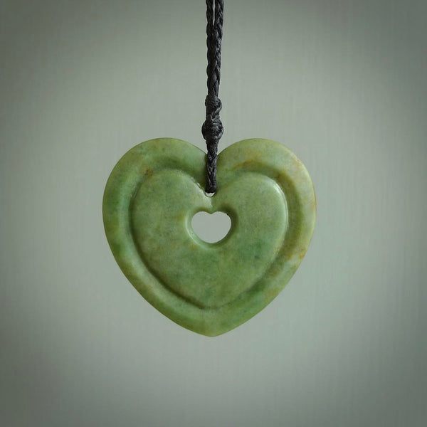 A large hand-carved Jade heart pendant. These are lovely pendants carved from exquisite New Zealand pounamu. Free worldwide delivery. Delivered to you on an adjustable cord.