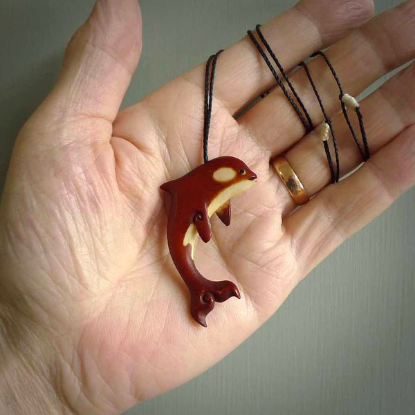 Stained Bone and natural bone orca. Hand carved pendant made by NZ Pacific. Hand carved Bone orca necklace hand made by Yuri Terenyi.