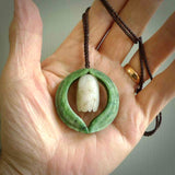 This photo shows a beautiful jade necklace with white siberian Jade. It is hand carved from jade and siberian jade. We have this on a brown coloured, adjustable cord. We ship this worldwide with an express courier service. Postage is free.