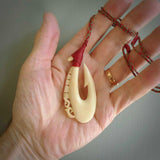 Natural cow bone hook with Manaia pendant. Hand carved by Yuri Terenyi in New Zealand. Maori design pendant for sale online. Natural bone manaia, hook necklace. Free delivery worldwide.
