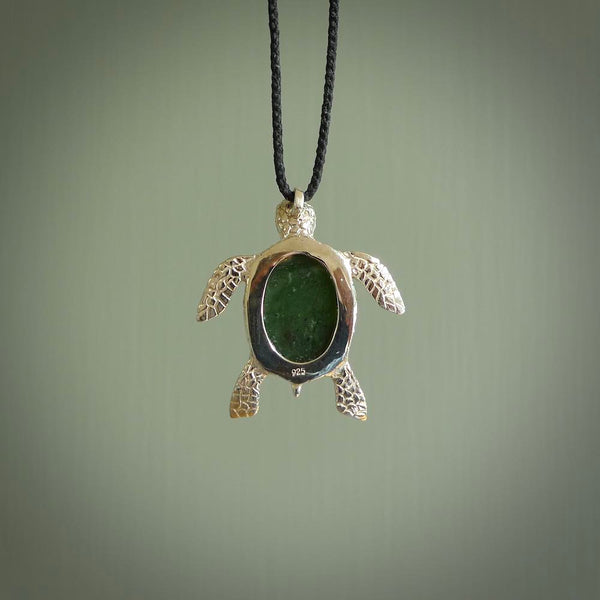 New Zealand Jade stone turtle in Sterling silver engraved casing. Hand carved jewellery made by NZ Pacific and for sale online. Moana, Ocean, jewellery hand carved in fire agate and Sterling Silver turtle necklace.