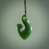 This matau is carved from a very striking New Zealand  jade. It is both intricate and simple in design - it has hidden folds and smooth curves. A piece to be worn or displayed - the carving and the jade are both magnificent. One only jade hook necklace hand made by Ric Moor.