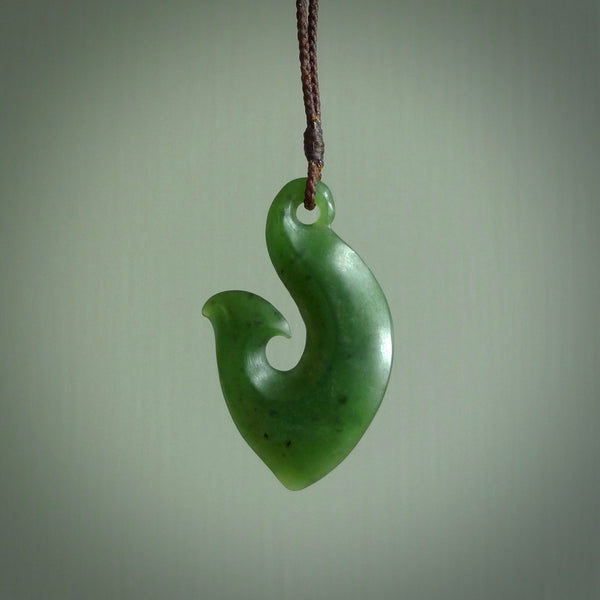 This matau is carved from a very striking New Zealand  jade. It is both intricate and simple in design - it has hidden folds and smooth curves. A piece to be worn or displayed - the carving and the jade are both magnificent. One only jade hook necklace hand made by Ric Moor.