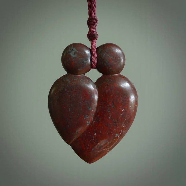 This is a handcarved love heart pendant made from a gorgeous and striking piece of red jasper stone. This is a superbly carved and very unique piece if custom jewellery. For sale online from NZ Pacific. Two sizes available; Medium and Large.